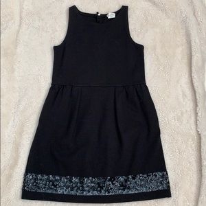 Black knit dress with sequin hem detail.